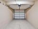 The garage features a white door and concrete floors at 2119 Kings Palace Dr, Riverview, FL 33578