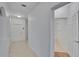 Hallway featuring neutral tile floors and access to a bathroom at 2119 Kings Palace Dr, Riverview, FL 33578