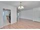 Open concept living and kitchen area with wood-look floors and an elegant chandelier at 2119 Kings Palace Dr, Riverview, FL 33578