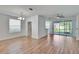 Bright living room with wood floors, ceiling fan, and sliding door access to a screened-in patio at 2119 Kings Palace Dr, Riverview, FL 33578