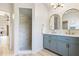 Bathroom boasting double sinks, modern fixtures, and a walk-in shower featuring tile accents at 2449 Running Oak Ct, Spring Hill, FL 34608