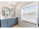 Bathroom boasting double sinks, modern fixtures, gold hardware, a window, and a seat at 2449 Running Oak Ct, Spring Hill, FL 34608