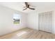 Clean bedroom featuring wood-look floors, a window, and large closet at 2449 Running Oak Ct, Spring Hill, FL 34608
