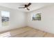 Bright, spacious bedroom with natural light from two windows and wood-look floors at 2449 Running Oak Ct, Spring Hill, FL 34608