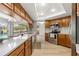 Modern kitchen with stainless steel appliances, stylish lighting, and a clear view to the screened in pool at 2449 Running Oak Ct, Spring Hill, FL 34608