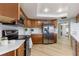 Well-equipped kitchen with stainless steel appliances, ample counter space, and stylish wooden cabinetry at 2449 Running Oak Ct, Spring Hill, FL 34608