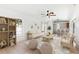 Comfortable living room with tile floors, a ceiling fan, and an open view of the kitchen and backyard at 2449 Running Oak Ct, Spring Hill, FL 34608