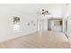 Bright living room with tile floors, a ceiling fan, and sliding glass doors at 2449 Running Oak Ct, Spring Hill, FL 34608