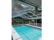 Screened-in pool offers a refreshing escape with clear blue water and ample space for relaxation and entertainment at 2449 Running Oak Ct, Spring Hill, FL 34608