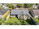 Aerial view of a home with a screened-in patio and lush green yard at 28402 Openfield Loop, Wesley Chapel, FL 33543
