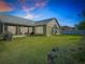 Expansive backyard featuring lush green grass, a screened-in lanai, and white vinyl privacy fencing at 28402 Openfield Loop, Wesley Chapel, FL 33543