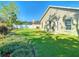 Expansive backyard featuring a lush green lawn, well-maintained landscaping, and a white privacy fence at 28402 Openfield Loop, Wesley Chapel, FL 33543