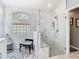 Spa-like bathroom showcasing a glass-enclosed shower with marble tile and a built-in bench at 28402 Openfield Loop, Wesley Chapel, FL 33543