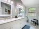 Modern bathroom with double vanity, marble countertop, and natural light at 28402 Openfield Loop, Wesley Chapel, FL 33543