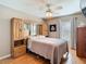 Bedroom featuring hardwood floors, built-in wardrobe and a TV at 28402 Openfield Loop, Wesley Chapel, FL 33543