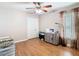 Bedroom with hardwood floors, ceiling fan, closet and work area at 28402 Openfield Loop, Wesley Chapel, FL 33543