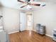 Well-lit bedroom with hardwood floors, ceiling fan and closet at 28402 Openfield Loop, Wesley Chapel, FL 33543