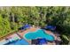 Aerial view of the community pool featuring lounge chairs and sun shades for residents' relaxation at 28402 Openfield Loop, Wesley Chapel, FL 33543