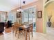 Formal dining area with decorative chandelier and sliding glass doors at 28402 Openfield Loop, Wesley Chapel, FL 33543