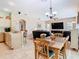 Open concept dining room into the kitchen and living room areas at 28402 Openfield Loop, Wesley Chapel, FL 33543