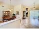 Traditional dining room featuring a wooden table, chandelier, and access to other living spaces at 28402 Openfield Loop, Wesley Chapel, FL 33543