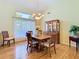 Bright dining area with hardwood floors, a large window, and a classic china cabinet at 28402 Openfield Loop, Wesley Chapel, FL 33543