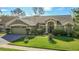 Charming home with a well-manicured lawn and beautiful landscaping at 28402 Openfield Loop, Wesley Chapel, FL 33543