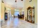 Spacious foyer with tile flooring leading to the dining room and front entrance of the house at 28402 Openfield Loop, Wesley Chapel, FL 33543