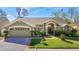 Charming one-story home with a well-manicured lawn, tasteful landscaping, and an attached two car garage at 28402 Openfield Loop, Wesley Chapel, FL 33543