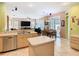 Open-concept kitchen with island, stainless steel dishwasher, and view to the living room at 28402 Openfield Loop, Wesley Chapel, FL 33543