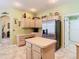 Bright kitchen with stainless steel refrigerator and island at 28402 Openfield Loop, Wesley Chapel, FL 33543