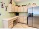 Kitchen area featuring neutral cabinets and stainless steel refrigerator at 28402 Openfield Loop, Wesley Chapel, FL 33543