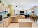 Open-concept kitchen with stainless steel appliances overlooking living and dining areas at 28402 Openfield Loop, Wesley Chapel, FL 33543