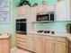 Featuring built-in stainless oven, gas cooktop and microwave at 28402 Openfield Loop, Wesley Chapel, FL 33543