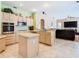 Bright kitchen featuring updated appliances, an island, and open view to the living room at 28402 Openfield Loop, Wesley Chapel, FL 33543