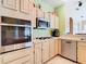 Charming kitchen featuring stainless steel appliances, light cabinets and an open layout at 28402 Openfield Loop, Wesley Chapel, FL 33543