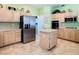 Kitchen with stainless steel refrigerator and appliances, ample cabinet space, and center island at 28402 Openfield Loop, Wesley Chapel, FL 33543