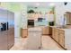 Well-equipped kitchen with stainless steel appliances, an island, and light-colored cabinets at 28402 Openfield Loop, Wesley Chapel, FL 33543