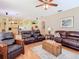 Spacious living room showcasing an open layout with kitchen view, wood floors, and ample seating at 28402 Openfield Loop, Wesley Chapel, FL 33543