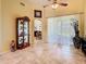 Bright living room with tile floors, sheer curtains, and a view of the outdoors at 28402 Openfield Loop, Wesley Chapel, FL 33543