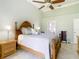 Cozy main bedroom with a plush bed, soft lighting, and a ceiling fan at 28402 Openfield Loop, Wesley Chapel, FL 33543