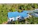 Aerial view of the recreation center with a blue metal roof surrounded by mature landscaping at 28402 Openfield Loop, Wesley Chapel, FL 33543