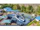Aerial view of the community splash pad and basketball court with mature trees and picnic area nearby at 28402 Openfield Loop, Wesley Chapel, FL 33543