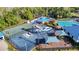 Aerial view of the community splash pad, featuring water slides, a playground, and a basketball court with sunshades nearby at 28402 Openfield Loop, Wesley Chapel, FL 33543