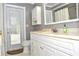 Bathroom featuring a white vanity, toilet, and door that leads to outdoor space, enhanced by natural light at 3189 Roxmere Dr, Palm Harbor, FL 34685