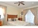 Bright bedroom featuring a ceiling fan, plush carpet, and natural light, creating a comfortable retreat at 3189 Roxmere Dr, Palm Harbor, FL 34685