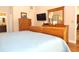 Bedroom showcasing wood floors and an attached bathroom, offering convenience and style in a private space at 3189 Roxmere Dr, Palm Harbor, FL 34685