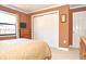 Bedroom with tan walls, carpet, and closet at 3189 Roxmere Dr, Palm Harbor, FL 34685