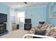 Bedroom with light blue walls, two windows, and entertainment system at 3189 Roxmere Dr, Palm Harbor, FL 34685