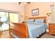 Bedroom featuring a wooden bed frame, hardwood floors, and natural light, providing an inviting atmosphere at 3189 Roxmere Dr, Palm Harbor, FL 34685